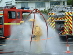 Photograph of fire service dealing with chemical spilage